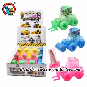 Camión de juguete con fábrica de caramelos de piruleta